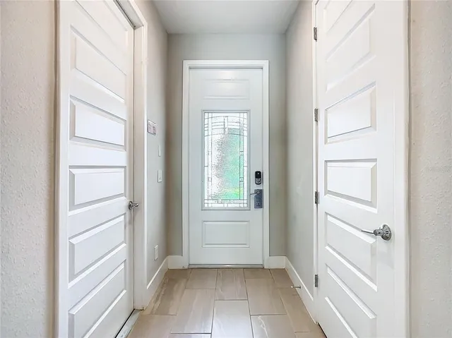 a view of an empty walk in closet with windows