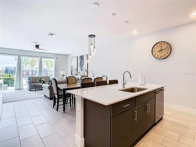 a view of kitchen with sink dining table and chairs