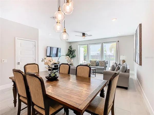a view of a dining room with furniture and chandelier