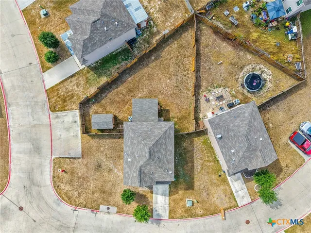an aerial view of a house with a swimming pool