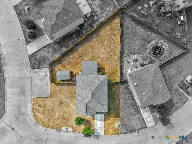 an aerial view of a house with outdoor space
