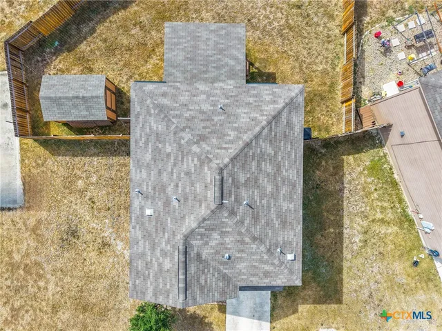 an aerial view of a house with a yard