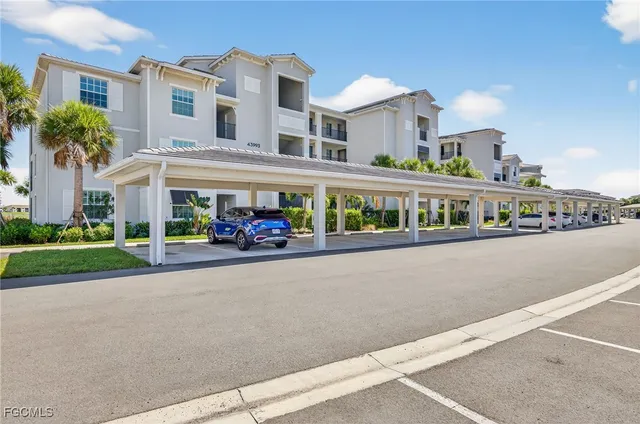 a front view of building with cars parked