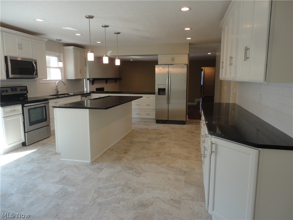 19646 Prospect Road Strongsville, OH 44149 - Photo 9 of 32 Completely redesigned kitchen featuring granite counter tops, self closing cabinets, center island for seating to enjoy those quick meals and top grade appliances.