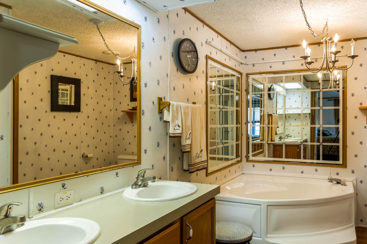 341 Union Valley Road Riner, VA 24149 - Photo 14 of 42 a bathroom with a granite countertop sink a toilet and shower