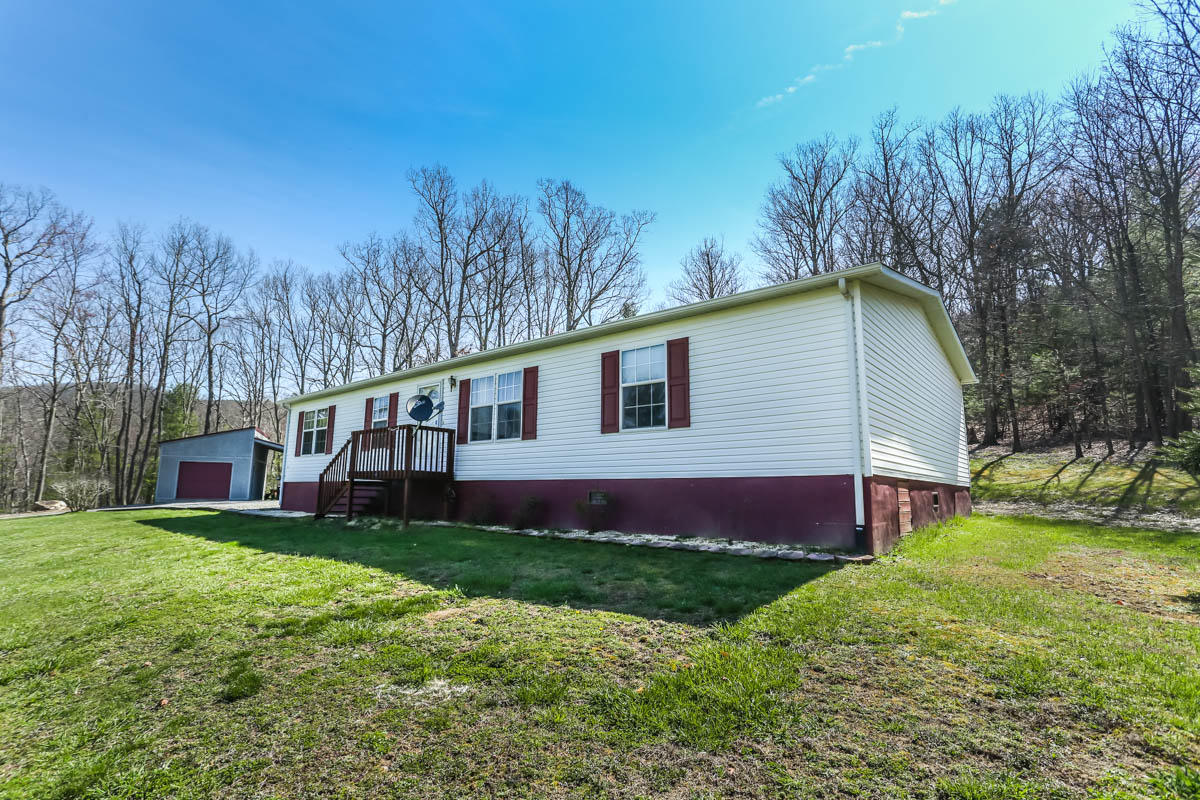 341 Union Valley Road Riner, VA 24149 - Photo 22 of 42 a view of house with backyard and trees