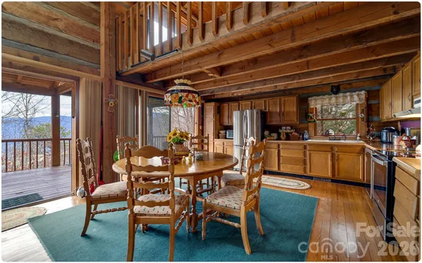 a dining room with furniture and wooden floor