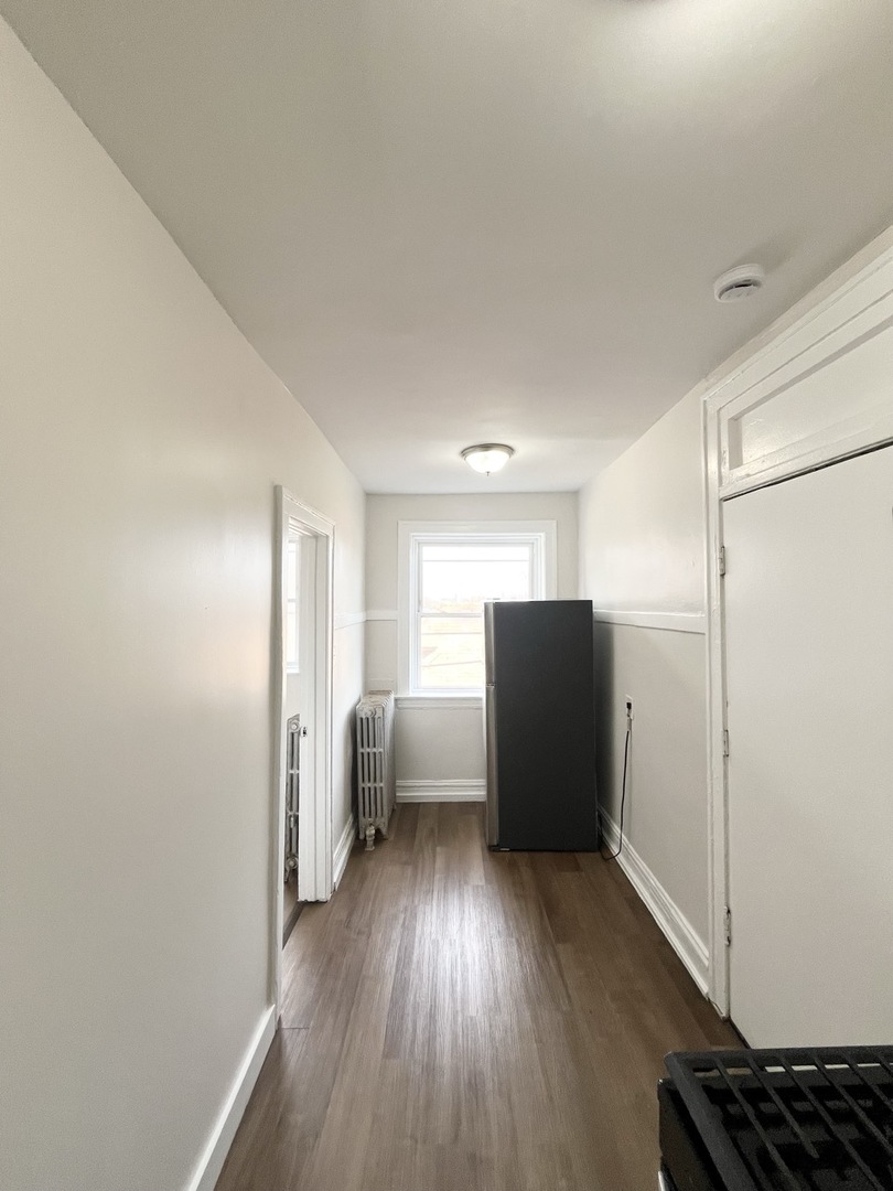 4134 West 24th Place, Unit E2 Chicago, IL 60623 - Photo 7 of 9 a view of a kitchen with refrigerator and wooden floor