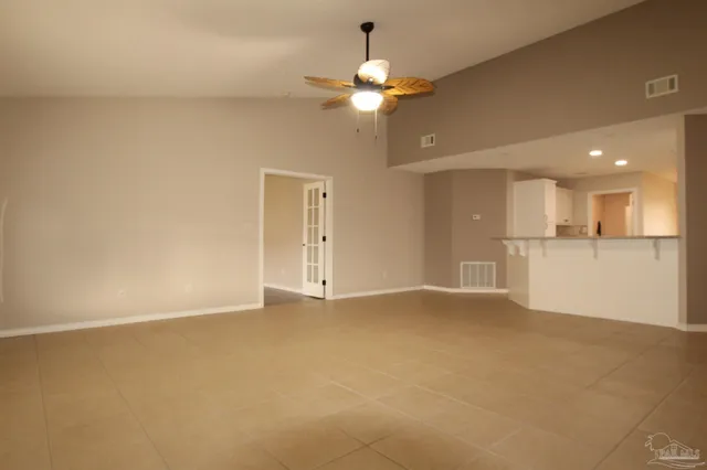 a view of an empty room with a kitchen