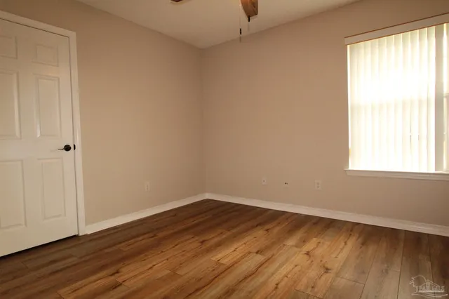 wooden floor in an empty room with a window