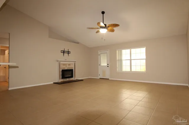 a view of an empty room with a fireplace and a window