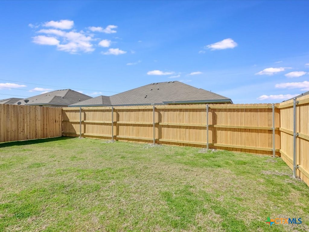 3805 El Paso Drive, Unit A Killeen, TX 76549 - Photo 18 of 20 a view of a backyard with a garden and wooden fence