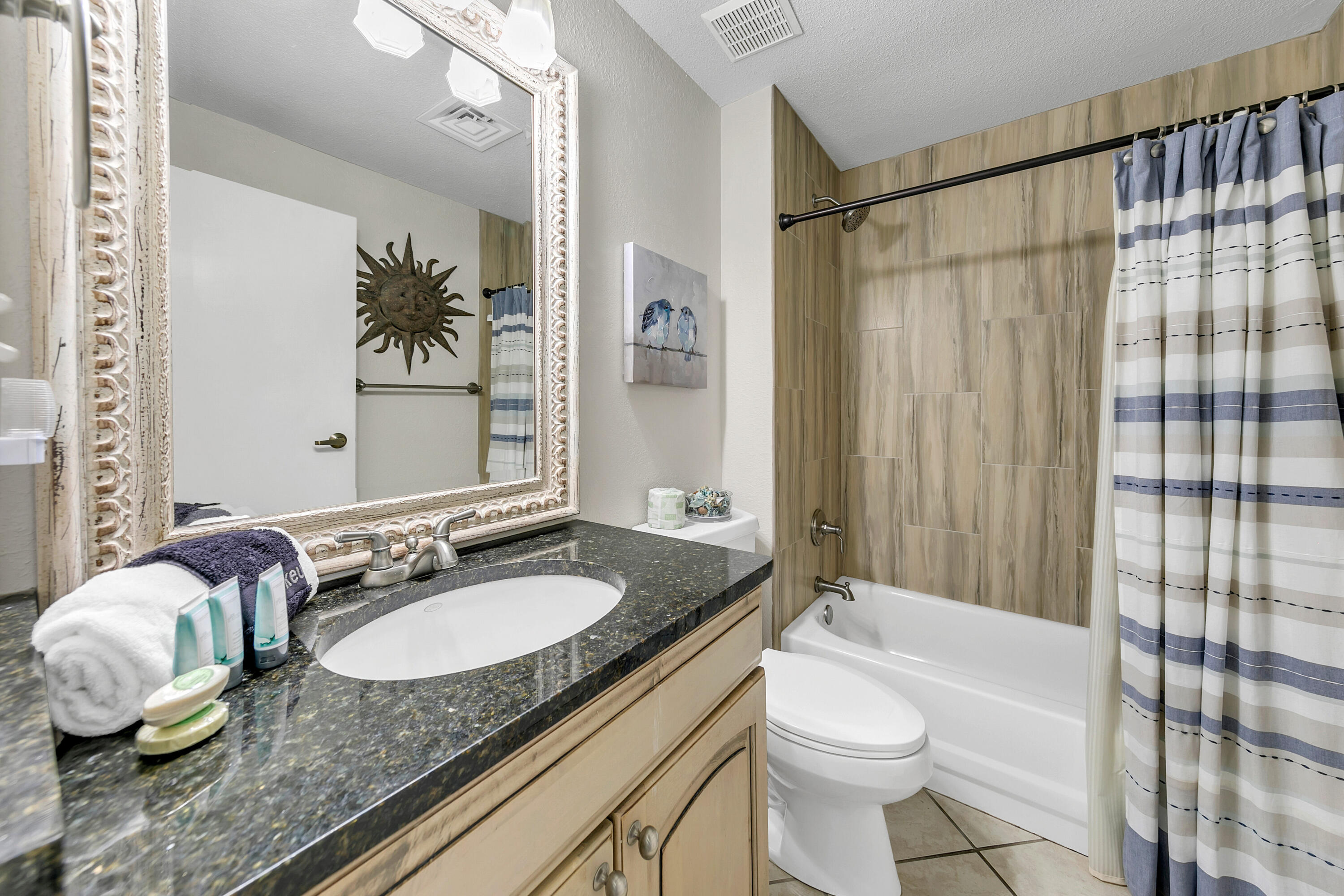 515 Tops'l Beach Boulevard, Unit 913 Miramar Beach, FL 32550 - Photo 18 of 34 a bathroom with a granite countertop sink and a mirror a toilet