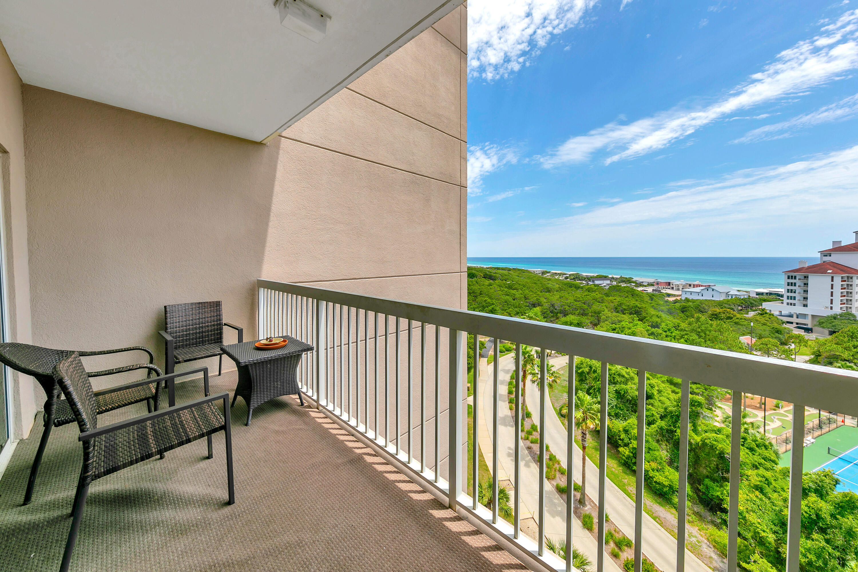 515 Tops'l Beach Boulevard, Unit 913 Miramar Beach, FL 32550 - Photo 19 of 34 a view of a balcony with wooden floor and outdoor seating