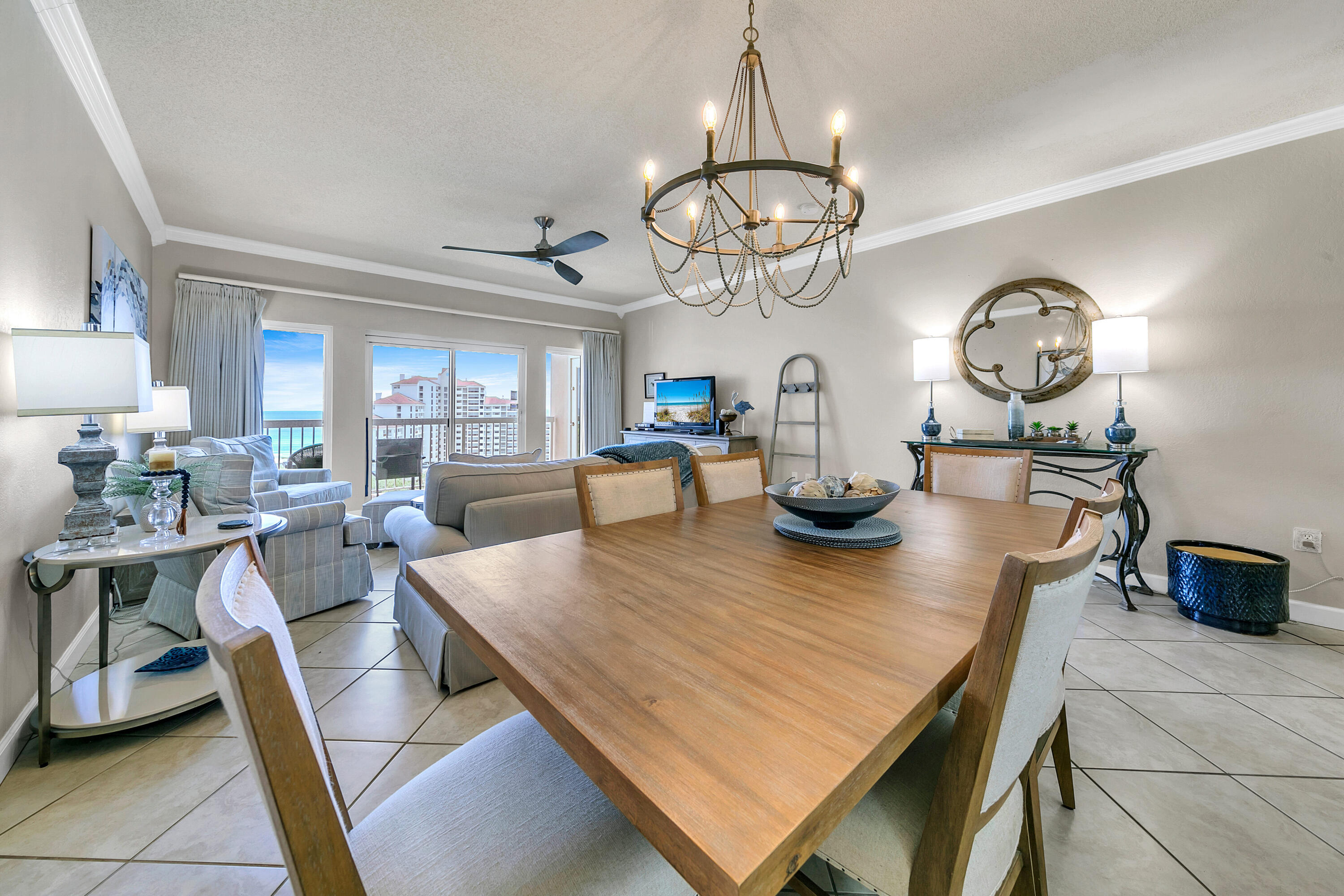 515 Tops'l Beach Boulevard, Unit 913 Miramar Beach, FL 32550 - Photo 7 of 34 a view of a dining room with furniture a chandelier and wooden floor