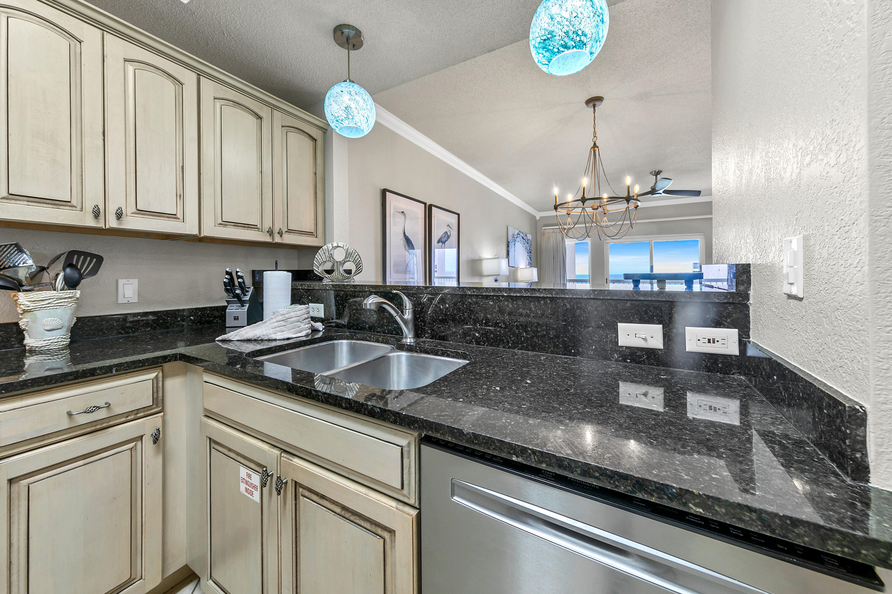 515 Tops'l Beach Boulevard, Unit 913 Miramar Beach, FL 32550 - Photo 9 of 34 a kitchen with granite countertop a sink a stove and cabinets