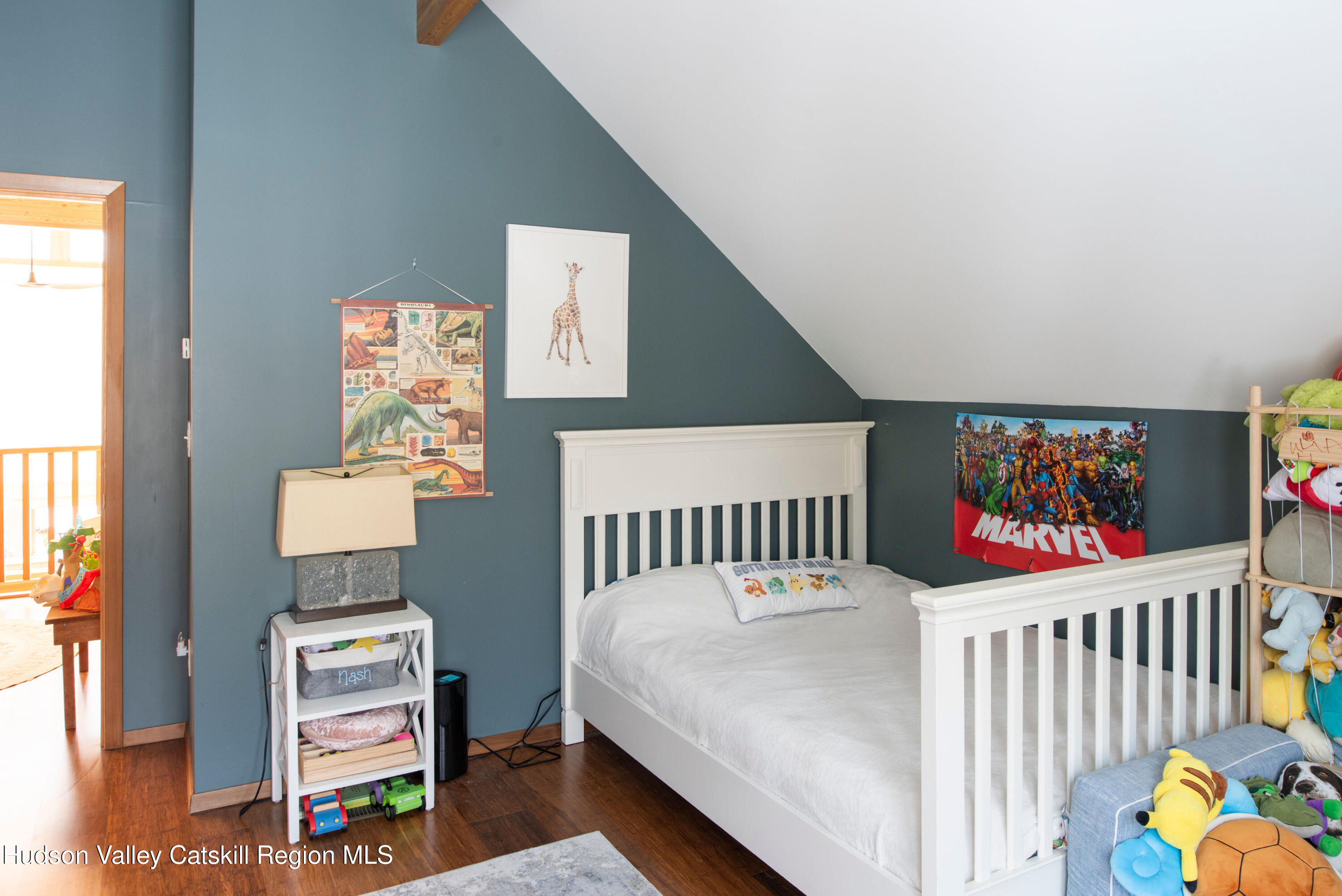 195 Vlei Road Rhinebeck, NY 12572 - Photo 17 of 24 a bedroom with furniture and a baby crib with wooden floor
