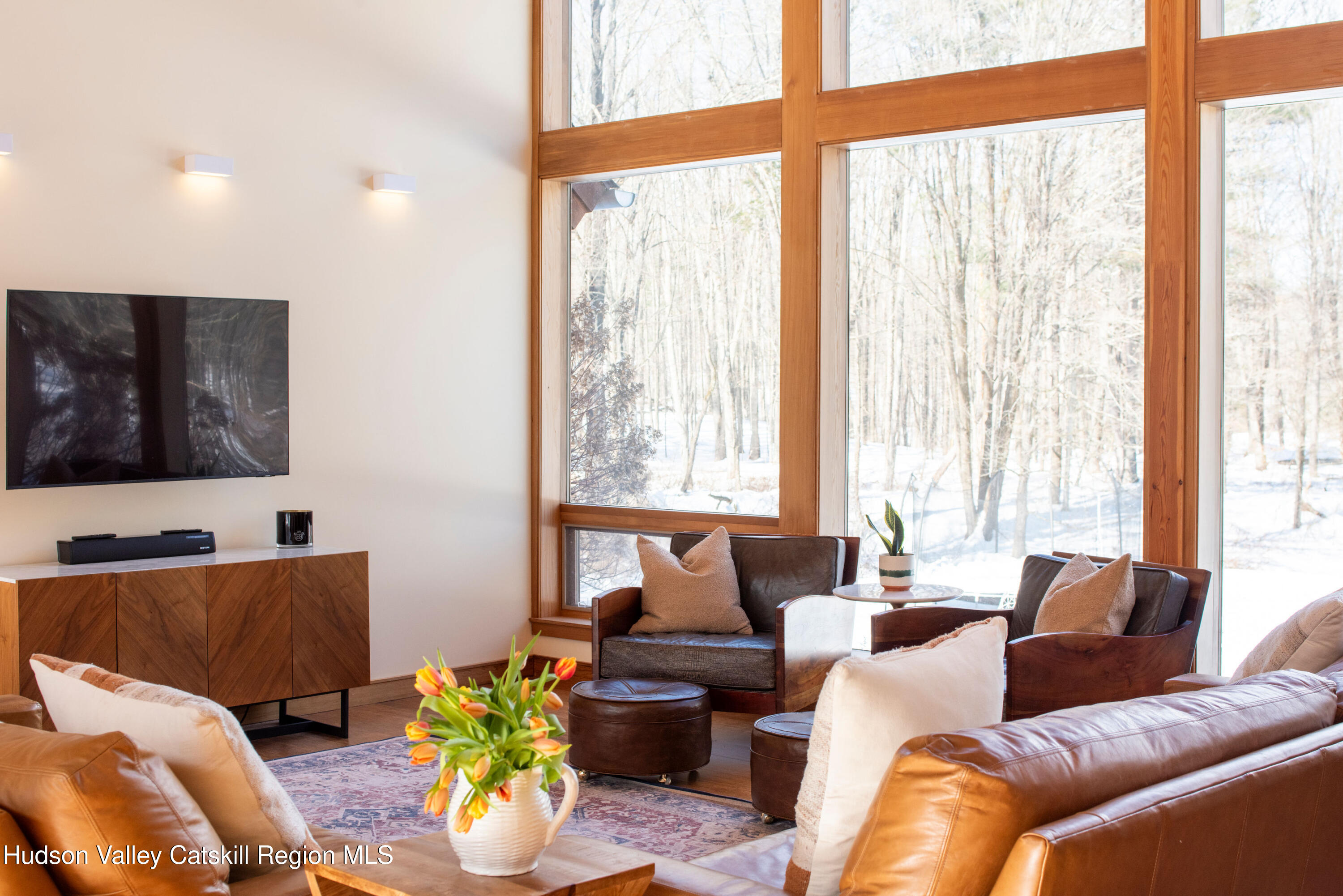 195 Vlei Road Rhinebeck, NY 12572 - Photo 9 of 24 a living room with furniture and floor to ceiling windows