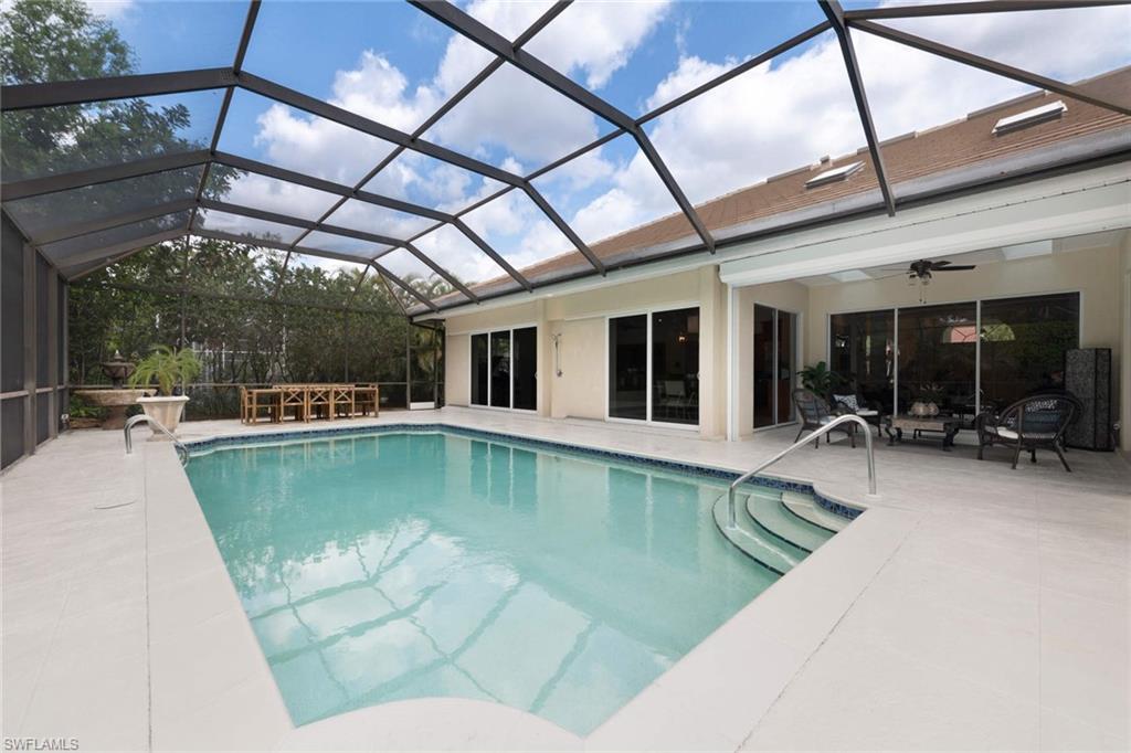 217 Silverado Drive Naples, FL 34119 - Photo 17 of 18 a view of a swimming pool with a patio