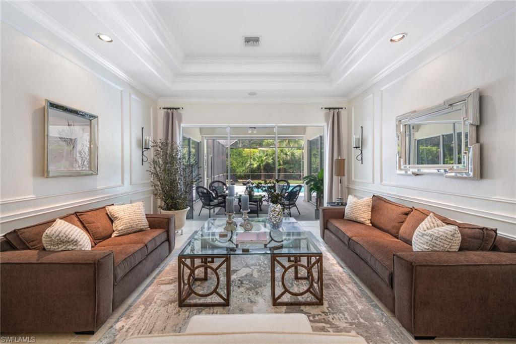 217 Silverado Drive Naples, FL 34119 - Photo 2 of 18 a living room with furniture and a large window
