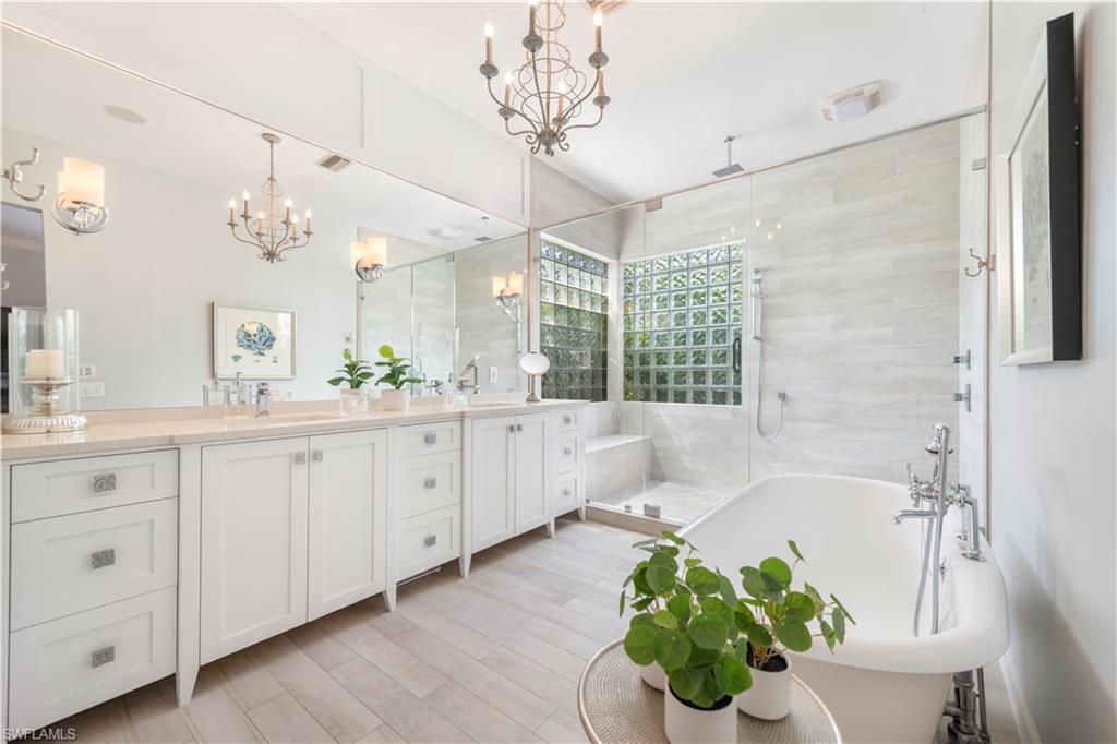 217 Silverado Drive Naples, FL 34119 - Photo 7 of 18 a bathroom with a bathtub sink and a shower