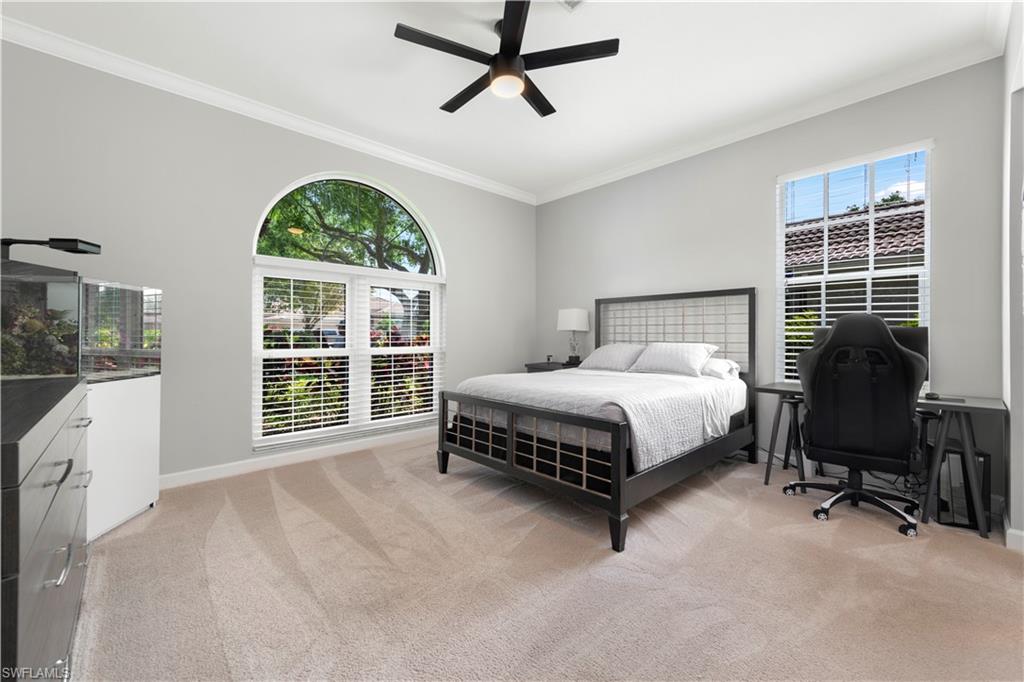 217 Silverado Drive Naples, FL 34119 - Photo 9 of 18 a spacious bedroom with a bed and a window