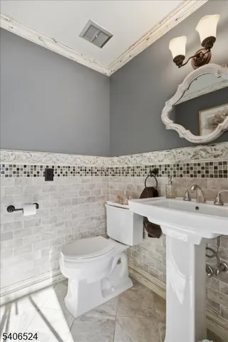 a bathroom with a sink a toilet and mirror