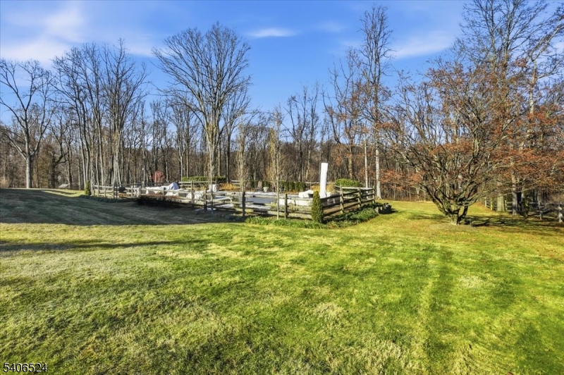 309 North Road Chester, NJ 07930 - Photo 28 of 37 a view of a swimming pool with lawn chairs under an umbrella
