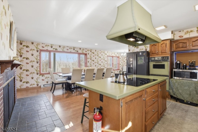 309 North Road Chester, NJ 07930 - Photo 10 of 37 a kitchen with stainless steel appliances granite countertop a sink a counter and chairs
