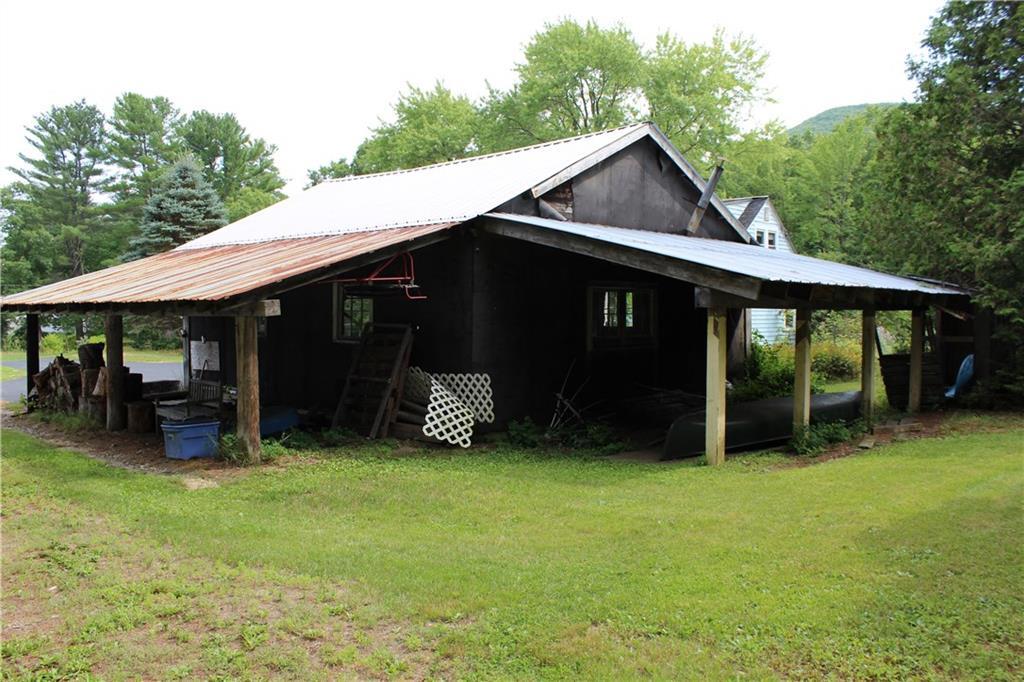 128 Spring Street Brownfield, ME 04010 - Photo 24 of 33 Garage has double carport for tons...