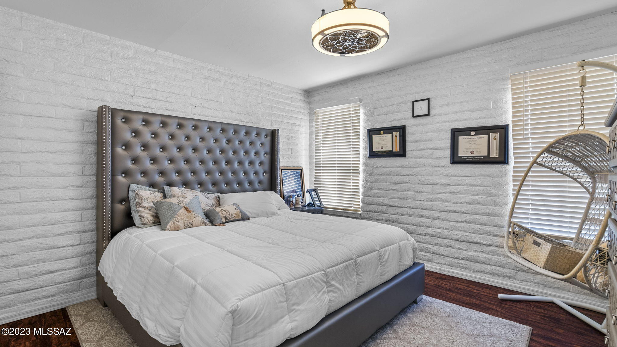 1176 Zircon Court Rio Rico, AZ 85648 - Photo 19 of 26 a bedroom with a bed and a chandelier