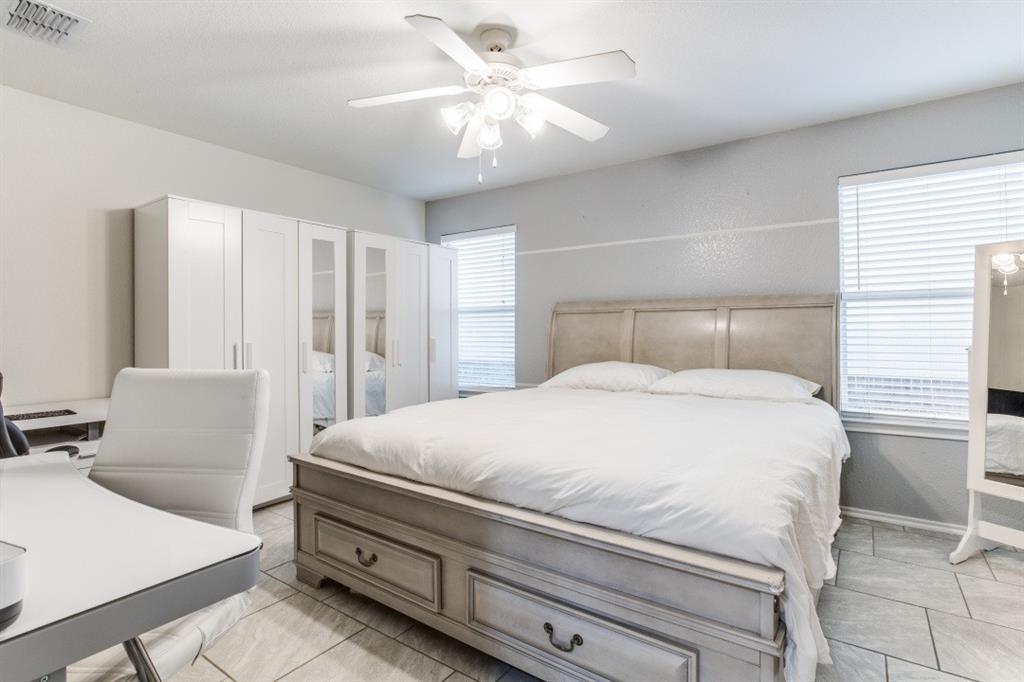 Undisclosed Address Austin, TX 78744 - Photo 11 of 18 a bedroom with a large bed and a chandelier