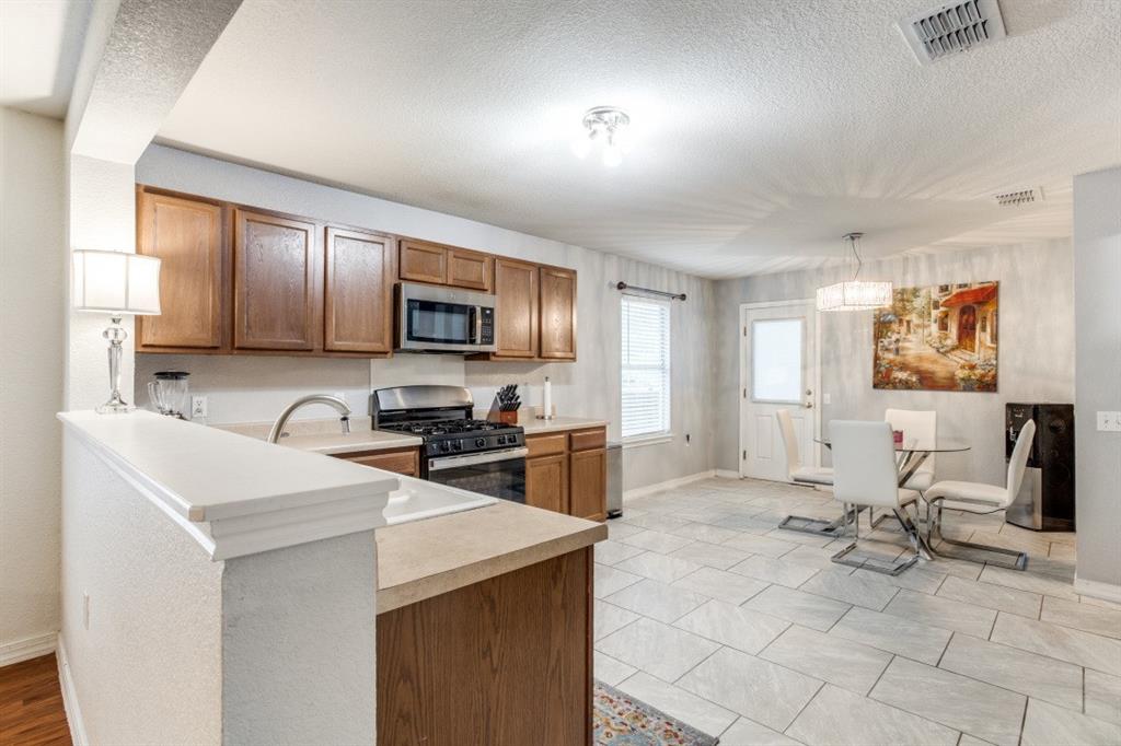 Undisclosed Address Austin, TX 78744 - Photo 6 of 18 a kitchen with a sink a counter top space appliances and cabinets
