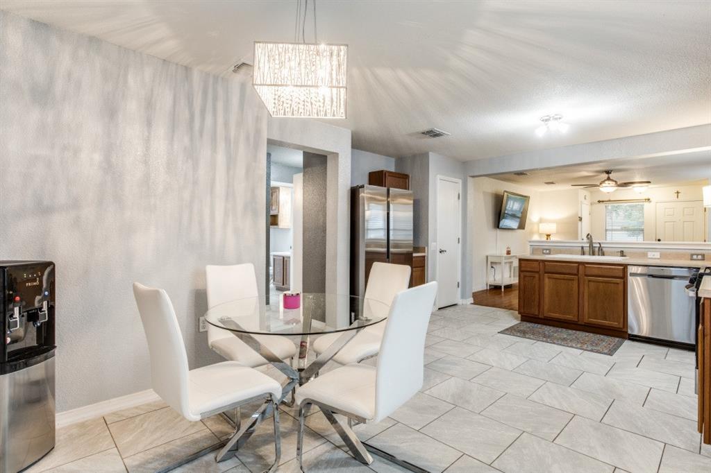 Undisclosed Address Austin, TX 78744 - Photo 7 of 18 a view of a dining room with furniture and a chandelier