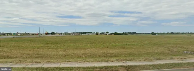 a view of a lake with houses in the back