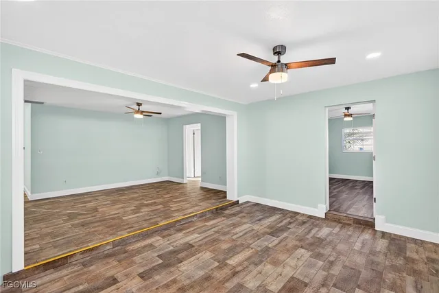 a view of a livingroom with a ceiling fan and window
