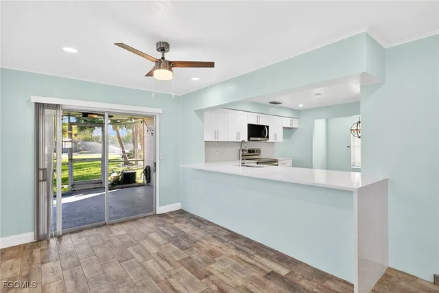a view of kitchen with sink and refrigerator
