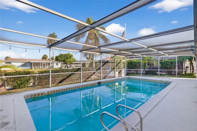 a view of a backyard with table and chairs