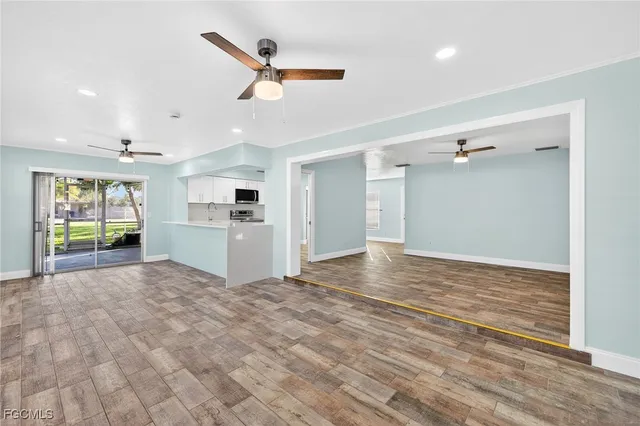 a view of a kitchen with a sink and a refrigerator