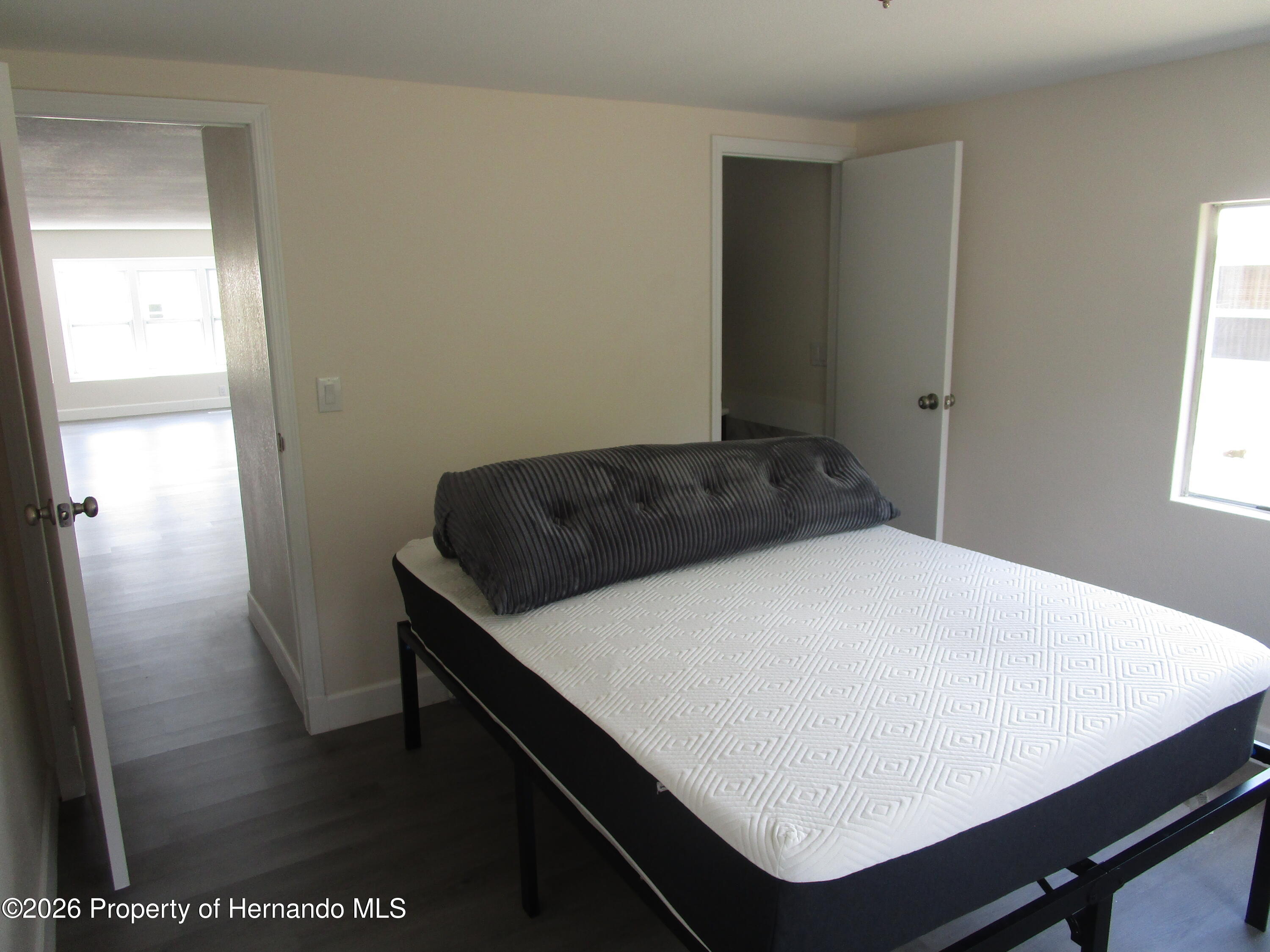 14790 Rialto Avenue, Unit 3 Brooksville, FL 34613 - Photo 9 of 15 a bedroom with a table and bed