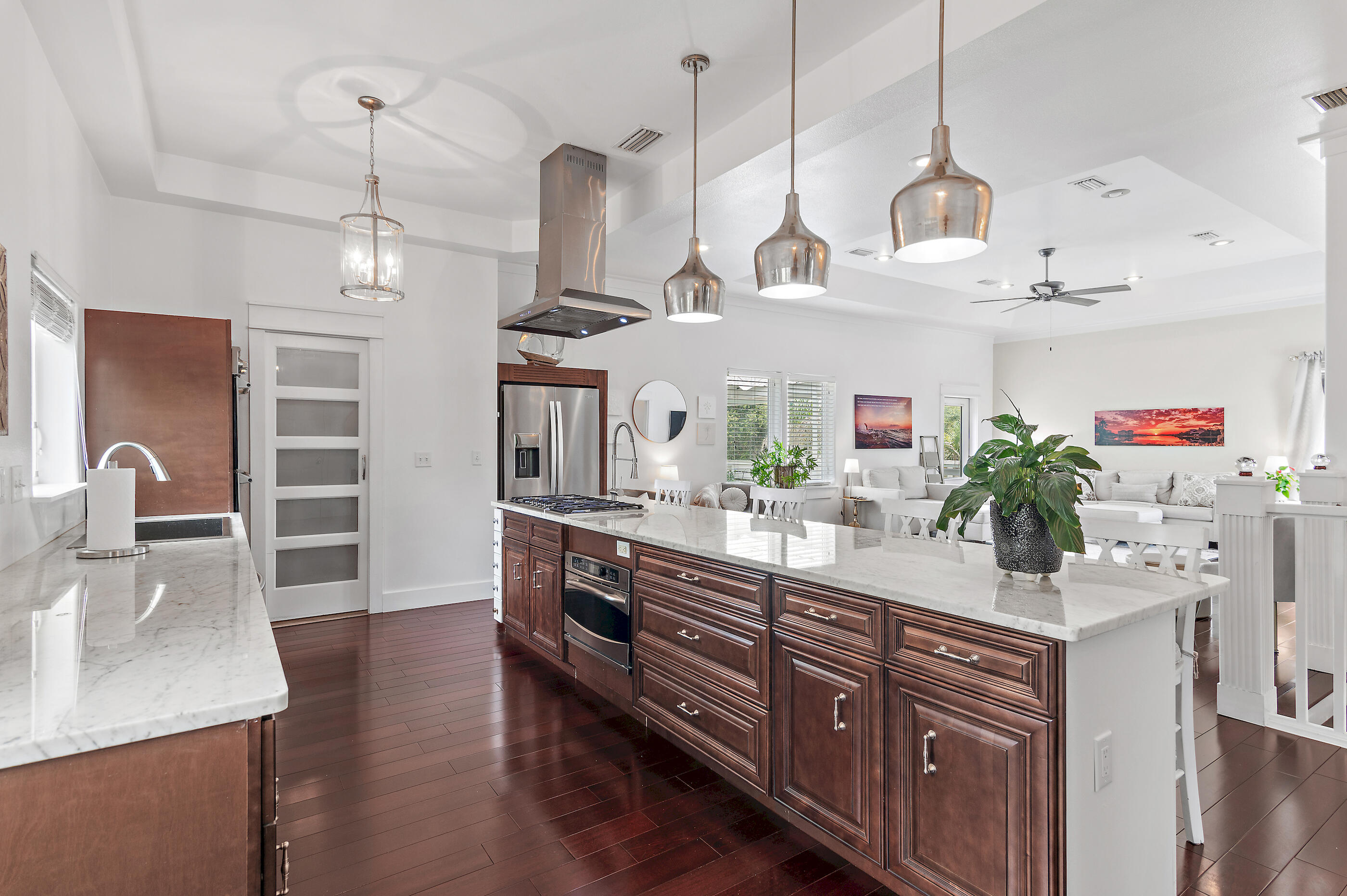 96 Hilltop Drive Santa Rosa Beach, FL 32459 - Photo 12 of 50 a kitchen with stainless steel appliances kitchen island granite countertop a sink a counter space and wooden floor