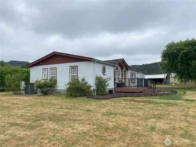 a backyard of a house with lots of green space and trees