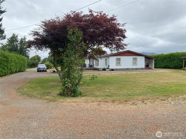 an empty room with wooden floor and a bathroom