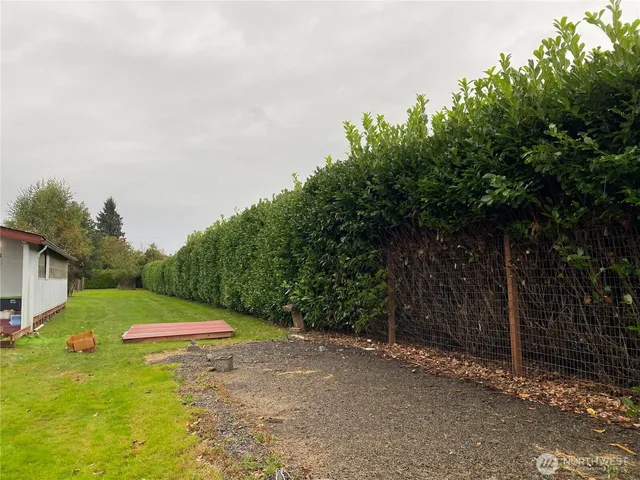 an empty room with wooden floor closet and windows