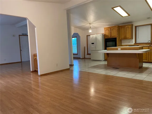 a front view of a house with a yard and trees