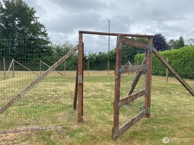 a view of a field with trees in the background
