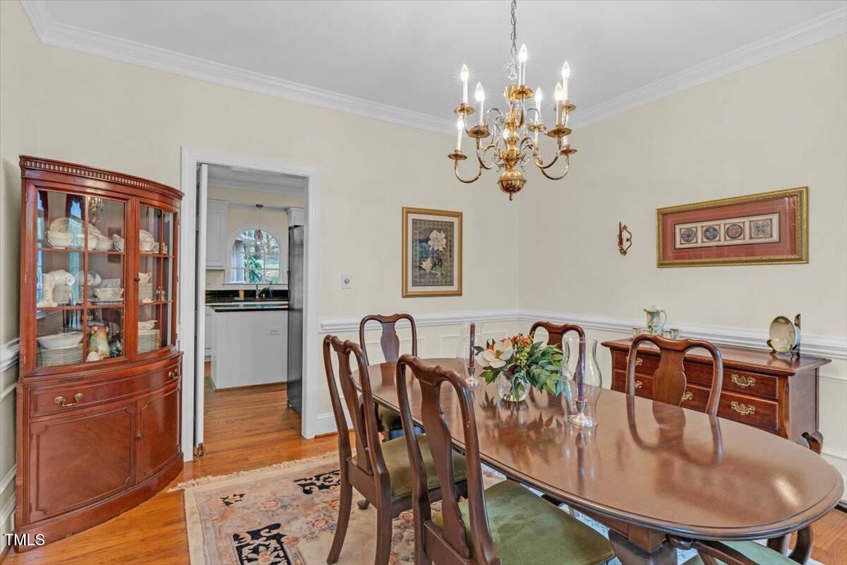 6245 Hampton Ridge Road Raleigh, NC 27603 - Photo 3 of 33 a view of a dining room with furniture window and wooden floor