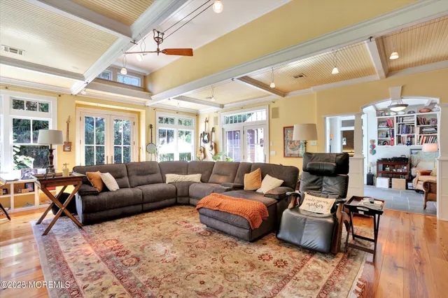 a view of a patio with table and chairs with wooden floor and fence