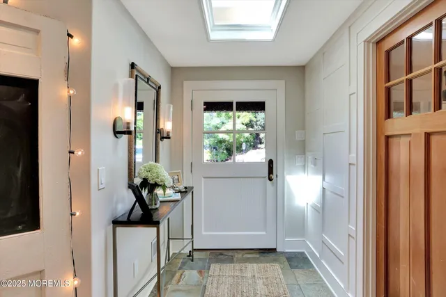 a living room with furniture and potted plants