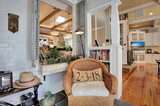 a bedroom with a bed a flat screen tv and windows